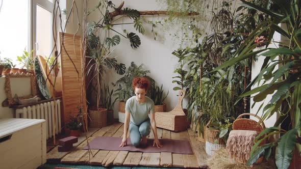 Young Woman Practicing Yoga Meditation at Home