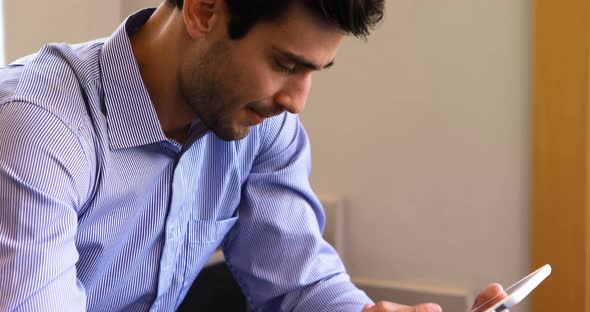 Male business executive using mobile phone in stairs 4k