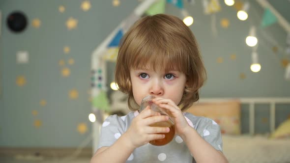 Girl Drinks Apple Juice From Bottle and Spills It on Tshirt