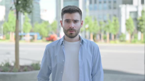 Young Man Pointing at the Camera Outdoor