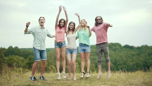People Jumping Outdoors. Group Of Friends Having Fun In Nature