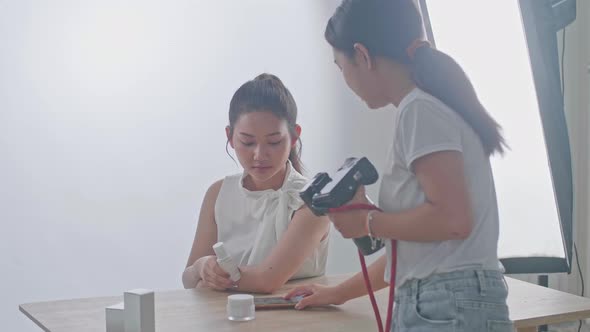 Young Asian Female Photographer Explain How To Pose To The Asian Model In Studio