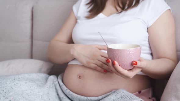 Pregnant Woman Eating Cornflakes with Milk