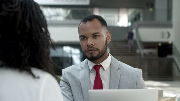 Concentrated Workers Discussing Business Questions