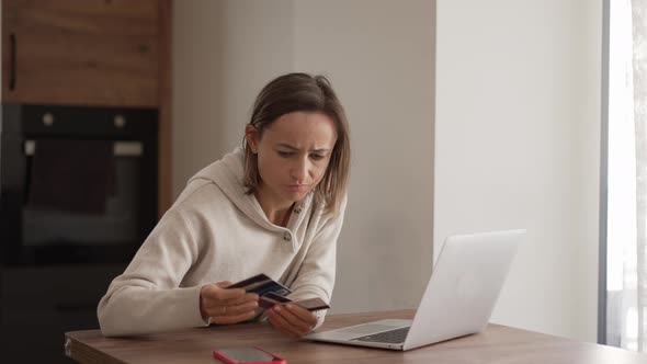 Upset Young Woman Using Online Banking Service Problem with Blocked Credit Card Using Laptop