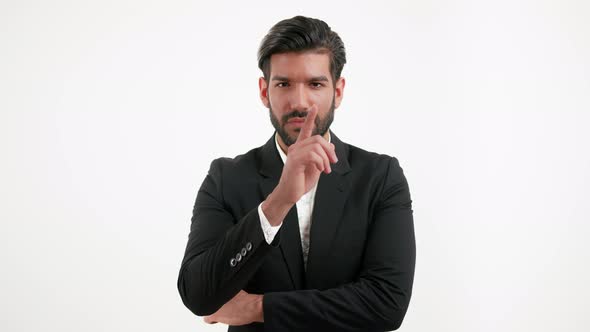 Handsome Stylish Hispanic Boss Showing Silence Finger Gesture Isolated Portrait Shot on White Studio