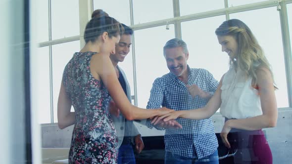 Group of smiling executives forming hand stack 4k