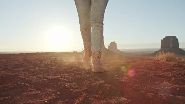 Low View of Female Feet in Boots Steps at Red Desert Landscape Woman Legs