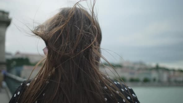 Outdoor Portrait of Pretty Cheerful Brunette on Windy Day