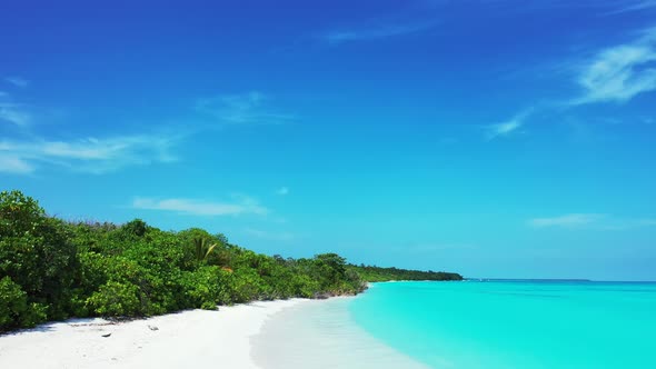 Tropical aerial tourism shot of a white sandy paradise beach and blue ocean background in colorful 4