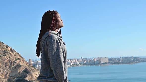 Black Woman Standing Over Sky and Sea and Breathing