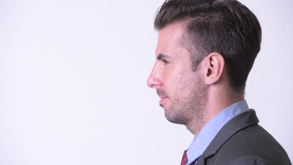 Profile View of Young Happy Hispanic Businessman