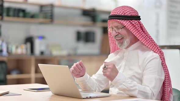 Excited Senior Old Arab Businessman Having Success on Laptop