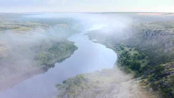 Aerial Drone View of Sunrise Over Misty River