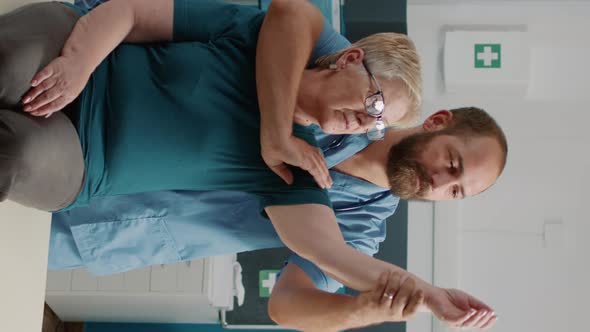 Vertical Video Orhopedic Specialist Doing Arms Stretch Exercise with Elder Patient