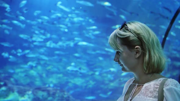 A Woman Admires the Underwater World in a Often Aquarium