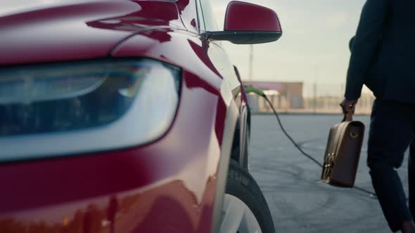 Close Up of Red Luxury Electric Car Charging at Modern Station