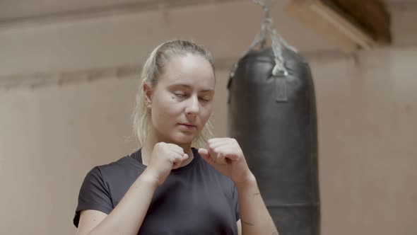 Medium Shot of Confident Female Boxer Getting Ready for Kick