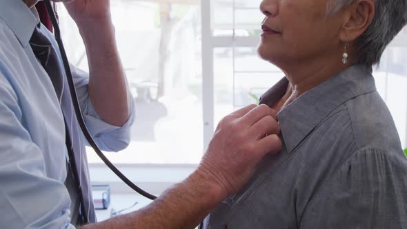 Doctor examining a senior woman in a retirement home