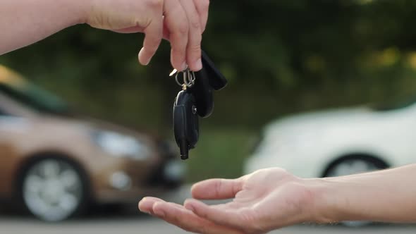 Man Gives a Car Key To the Other Man