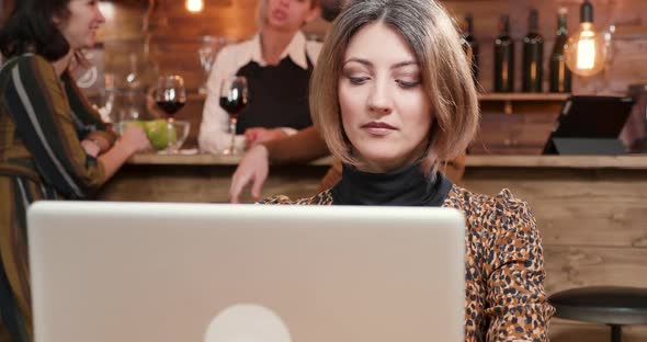 Woman Typing a Message and Waits for an Answer While Drinking Coffee