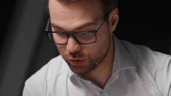 Portrait of a young man in eyeglasses explaining business strategy