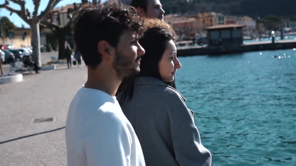 Slow motion shot of smiling friends at seafront