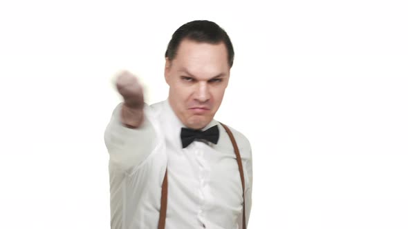 Portrait of Artistic Mature Man Wearing White Shirt and Bow Tie Looking at His Wrist Watch with Fun