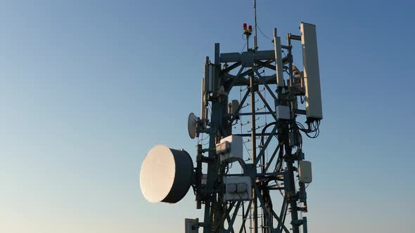 Silhouette of a communication tower for 5G network featuring cellular microwave wireless antenna.