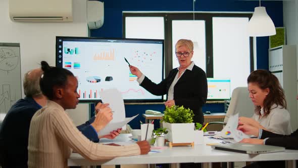 Chief Analyst Holding Meeting Presentation for a Team of Economists