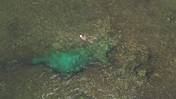 Aerial View- Men Surfers on a Surfboard Paddling in the Clear Shallow Sea, .