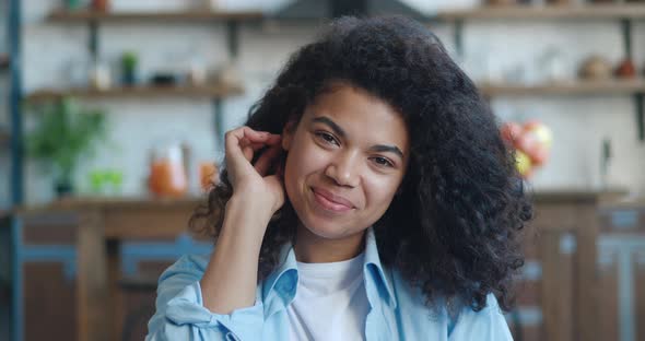 Beautiful Smiling Young African American Woman Looking at Camera Stand Indoors