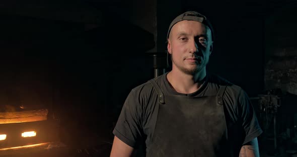 Portrait of a Young Guy in a Workshop