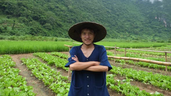 Young Asian Farmer In Vegetable Garden