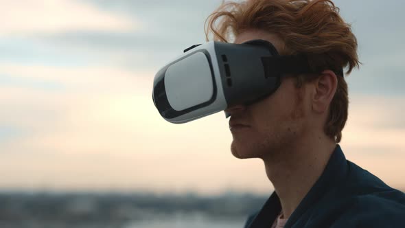 Red Haired Man Wearing VR Glasses on Fresh Air