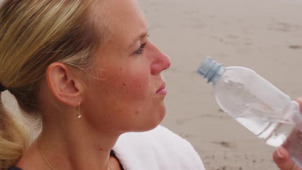 Woman drinking water after run. Shot on RED EPIC for high quality 4K, UHD, Ultra HD resolution.
