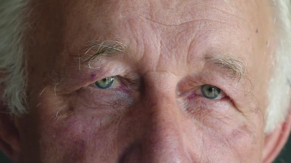 Macro Staring Into Camera of Senior Man with Blue Eyes