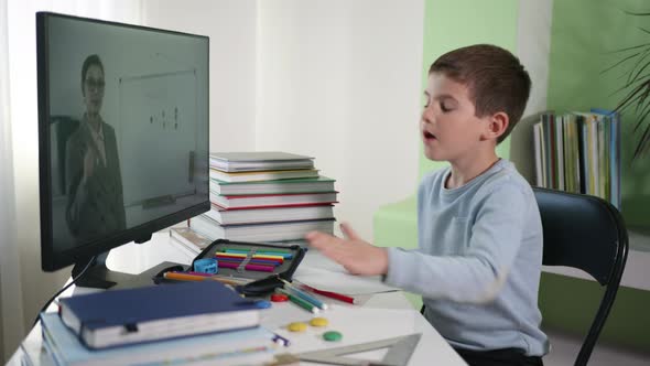 Child Learns Lessons Online with Teacher Using Modern Technology, Distance Education