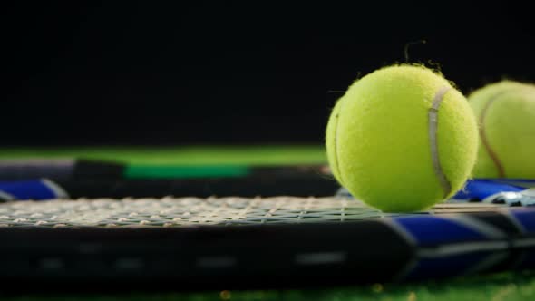 Tennis balls and racket in court