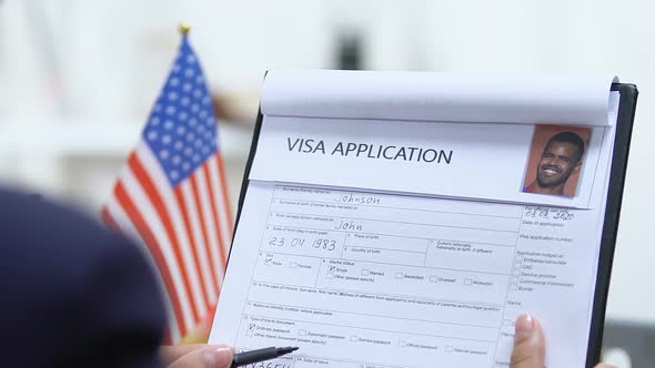 Female Manager Checking USA Visa Application, Marking Denied, Travel Forbidden