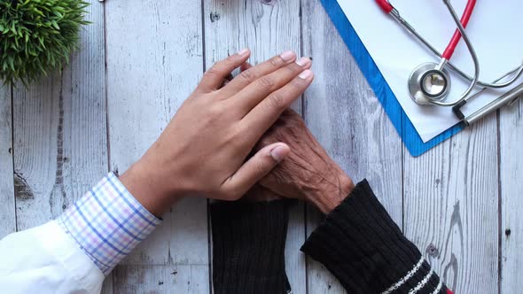 Doctor Holding Hand of a Senior Women