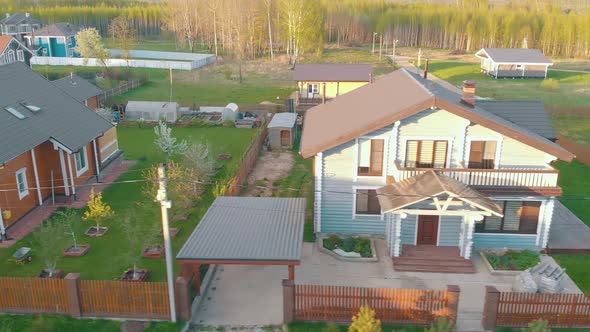 Wooden Cottage Houses with Red Roofs and Fresh Green Lawns