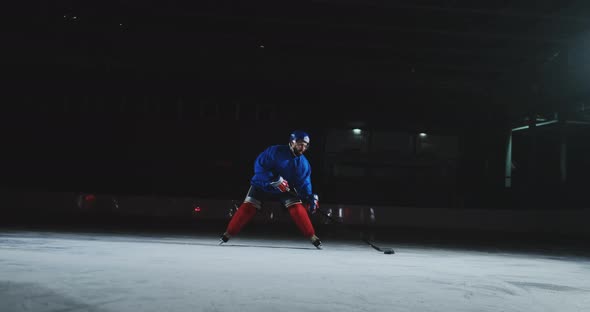 Two Professional Hockey Men Fighting for the Puck on the Ice Arena Using Force Techniques