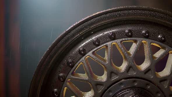 Beautiful Freshly Painted Rim From Car in Rain with Water Drops on Polished Shelves and Bolts