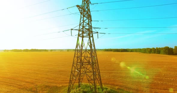 Vertical Movement Flight Near High Voltage Electricity Tower and Power Lines at Green and Yellow