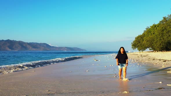 Lady alone loves life on marine coast beach lifestyle by shallow ocean and white sand background of 