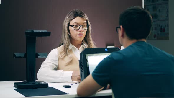 A Client in the Office Is Talking To a Cybernetic Assistant