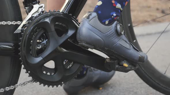 Leg in cycling road shoes clips out from pedals. Cycling concept