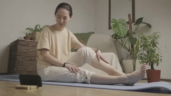 Young Woman is Exercising Fitness Lesson Online