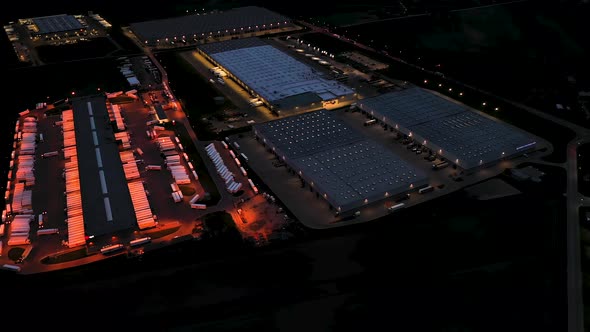 Aerial view of the large logistics park with warehouse, loading hub with many semi-trailers trucks s